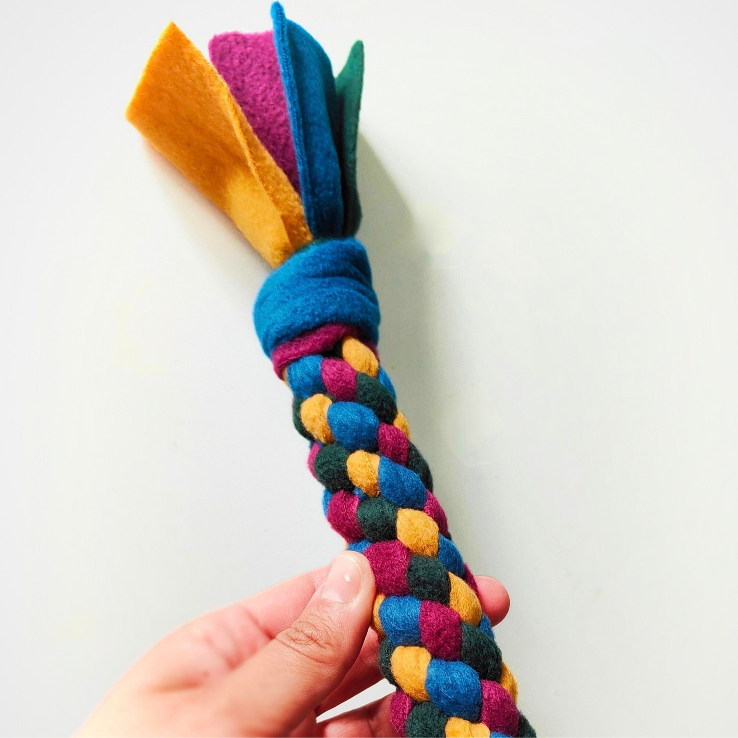 A Chonk Tug toy in a mix of vibrant colours, set against a white background, perfect for pet play.