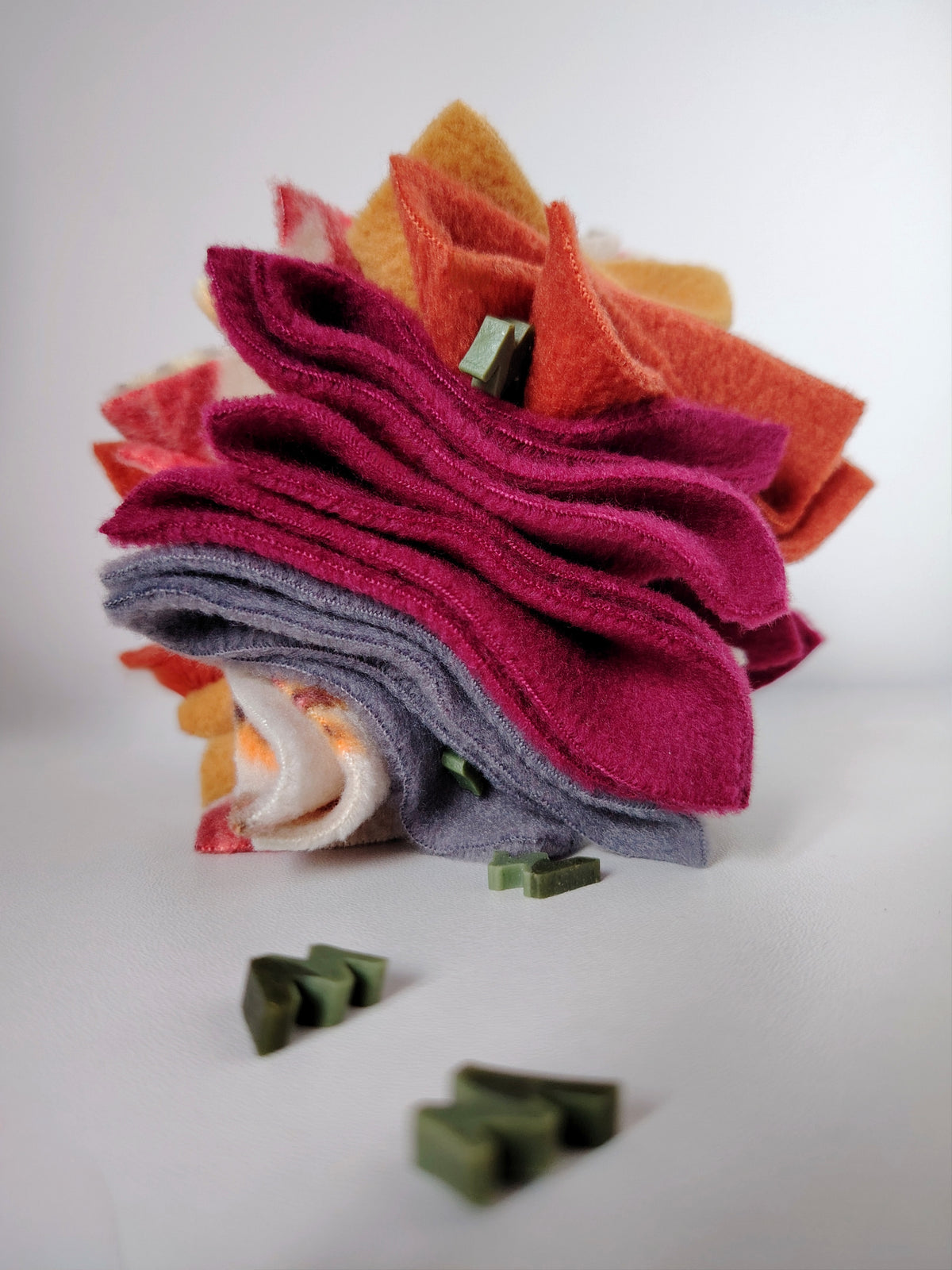 Autumn Scruffle Ball with W'ZIS dog treats hidden between layered plum, rust, mustard, green and grey fleece.