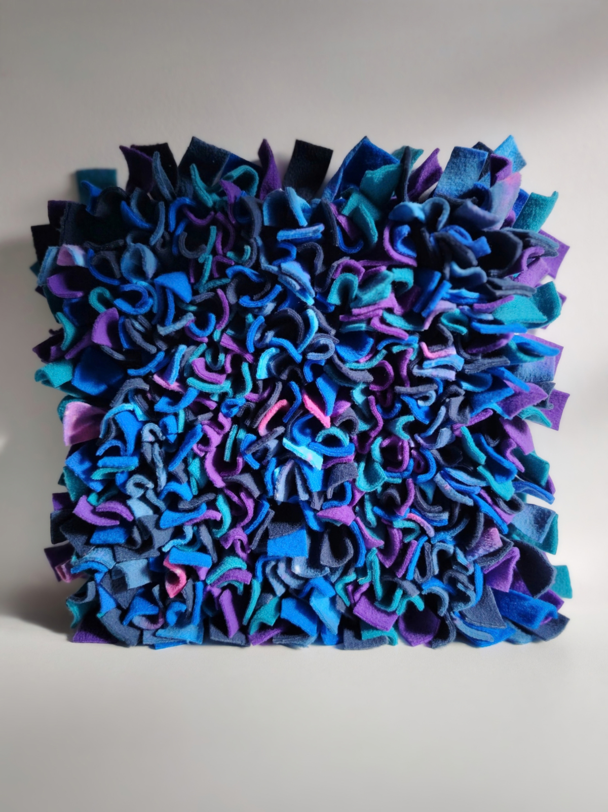 Full view of Nova Zeal's Night Sky Snuffle Mat, featuring densely packed navy, royal blue, teal, purple and galaxy-patterned fleece strips.