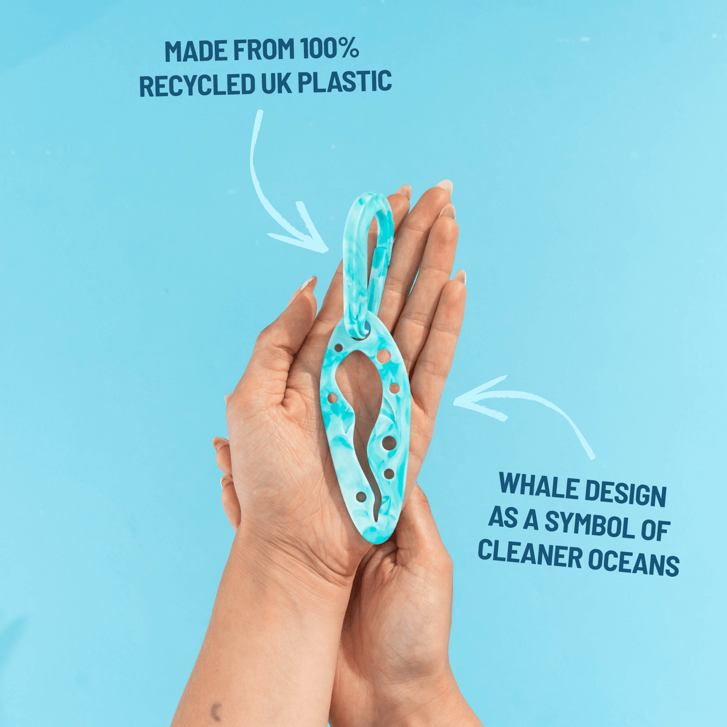 PooPal hands-free poo bag holder made from 100% recycled UK plastic with a whale-inspired design, shown in the palm of a hand.