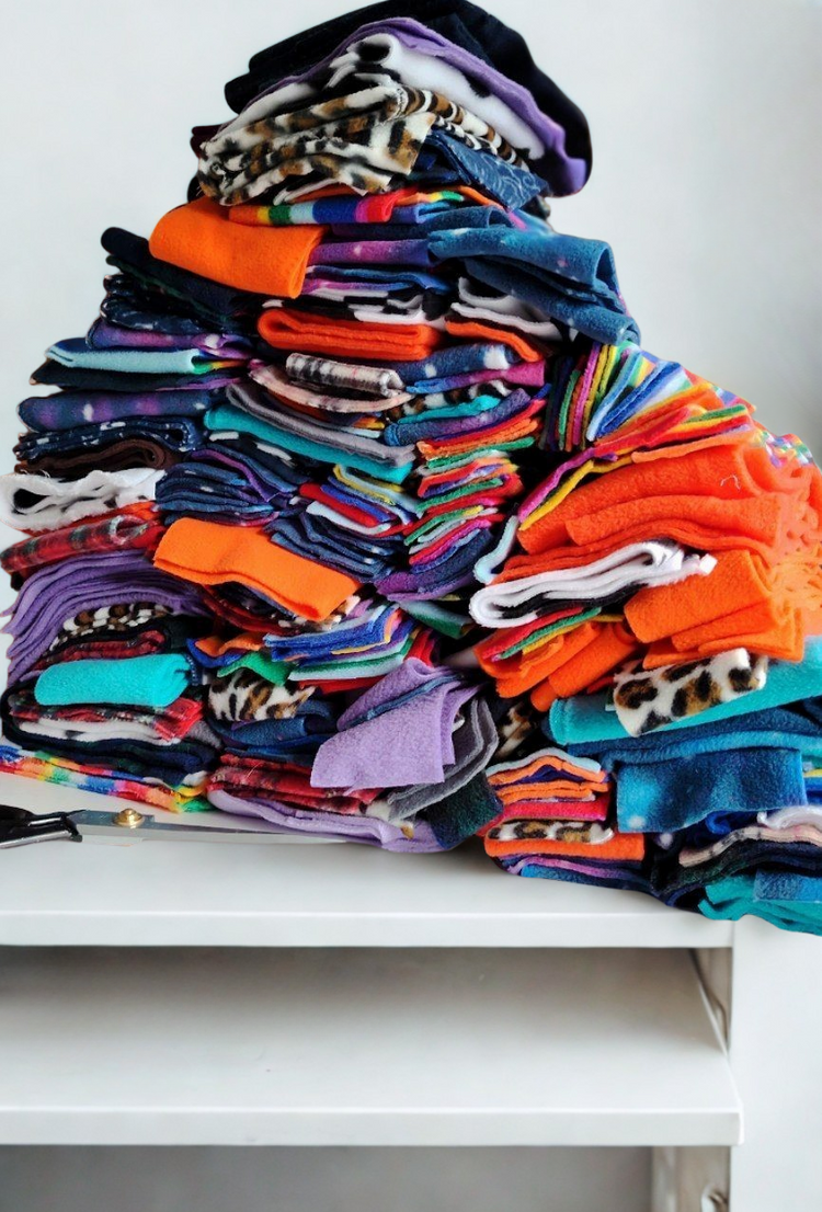 Stack of colourful fleece fabrics used to create Nova Zeal Design Roulette dog enrichment toys.
