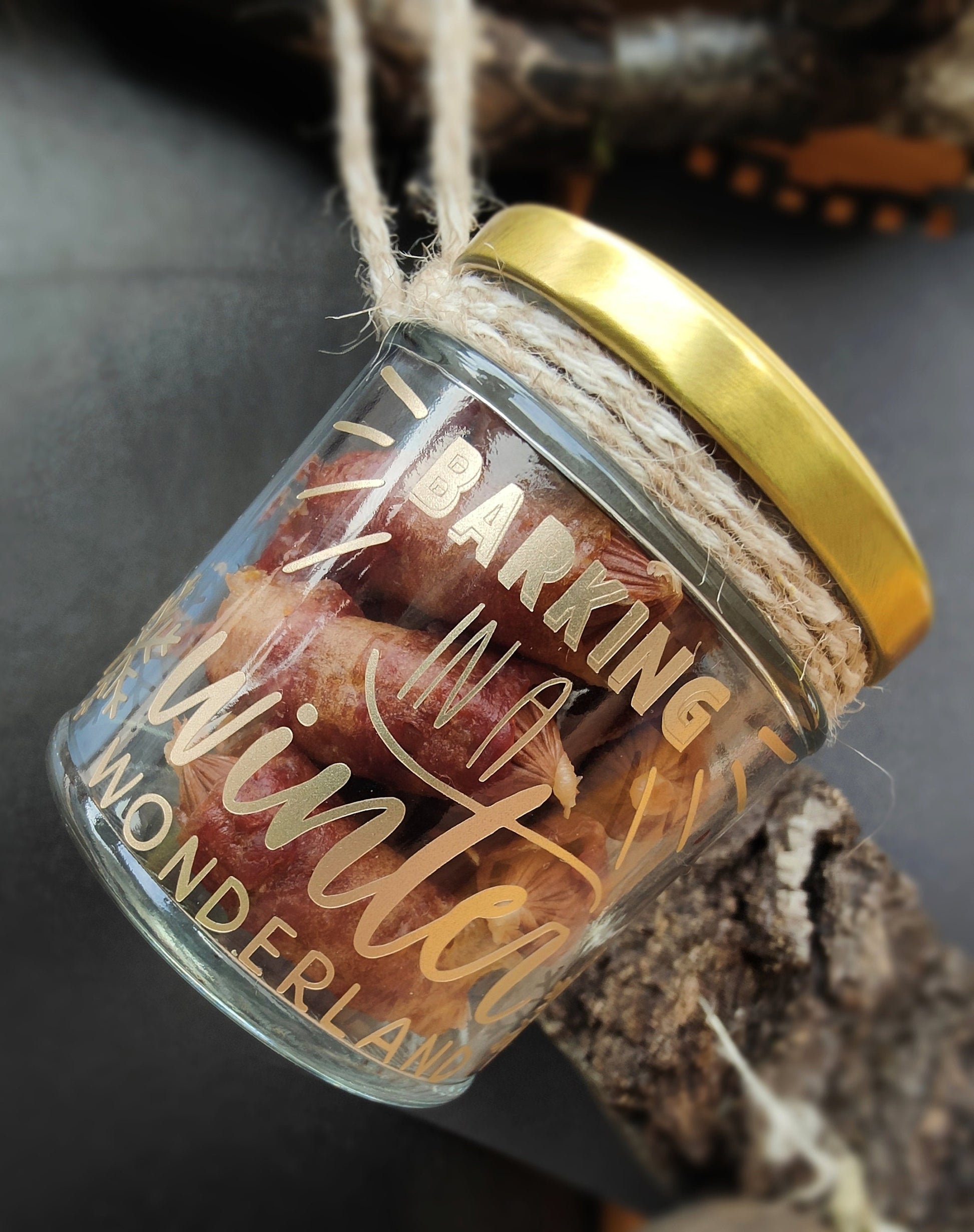 Glass jar with gold lid containing dog treats (as an example), labeled 'Barking in a Winter Wonderland', on a dark background.