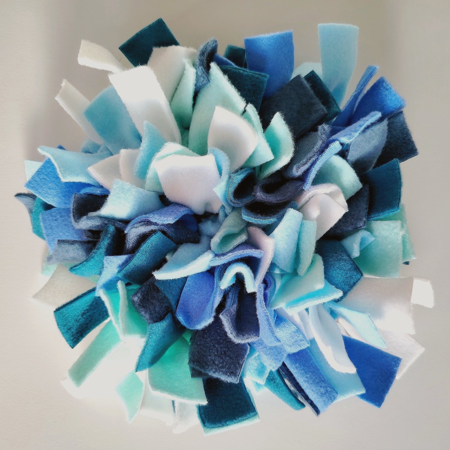 Close-up of soft fleece layers in cool-toned snuffle mat.