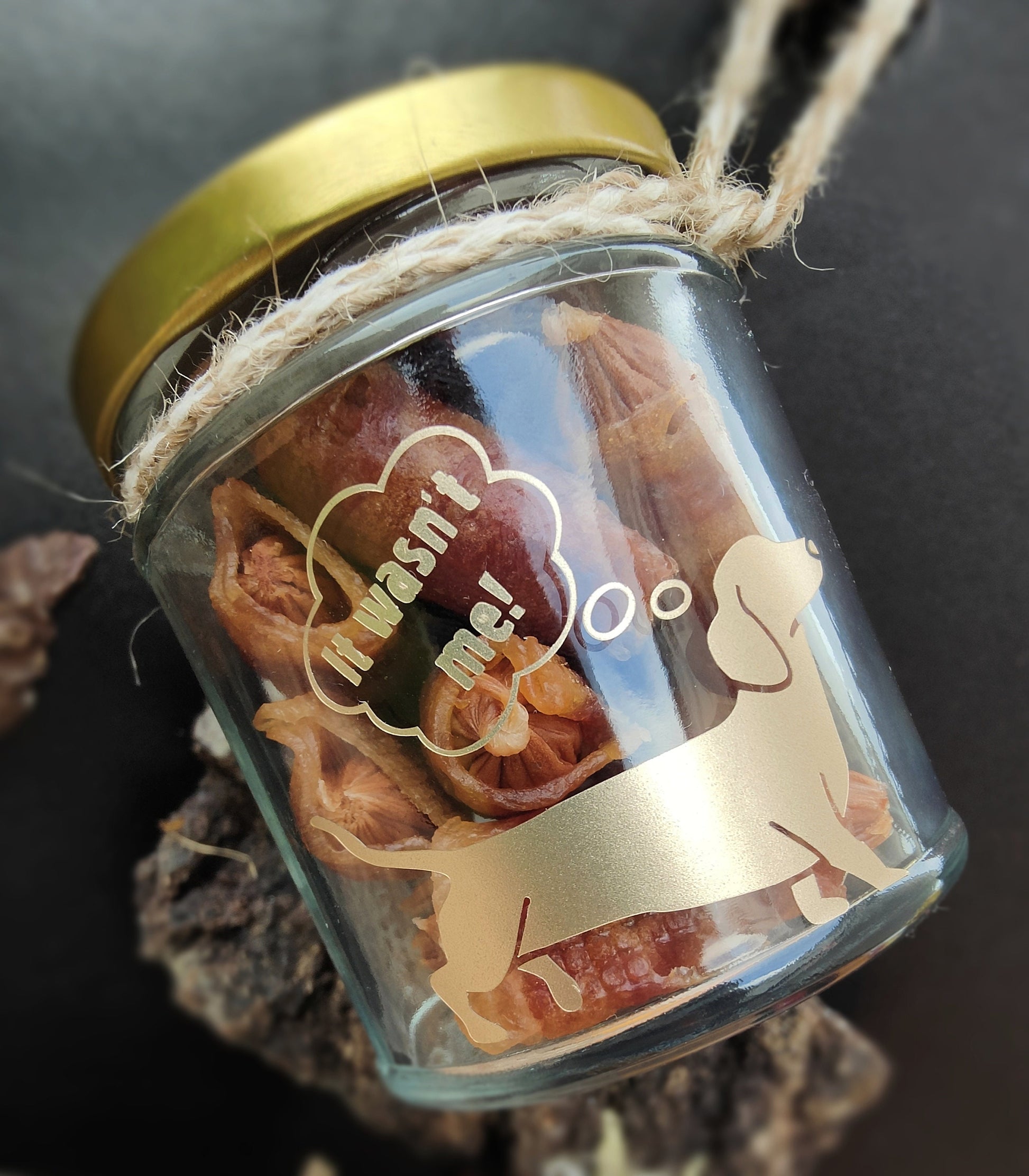 Glass jar with gold lid containing dog treats, showing a dachshund with a thought bubble,which says 'It wasn't me!'