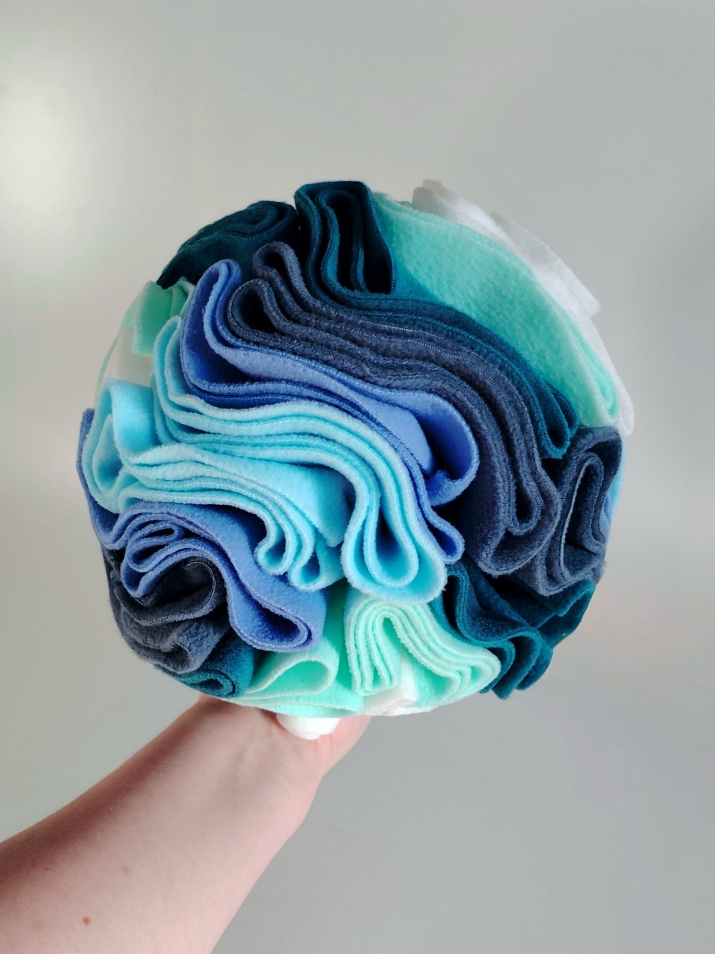 Large Nova Zeal snuffle ball held in hand showing size reference.