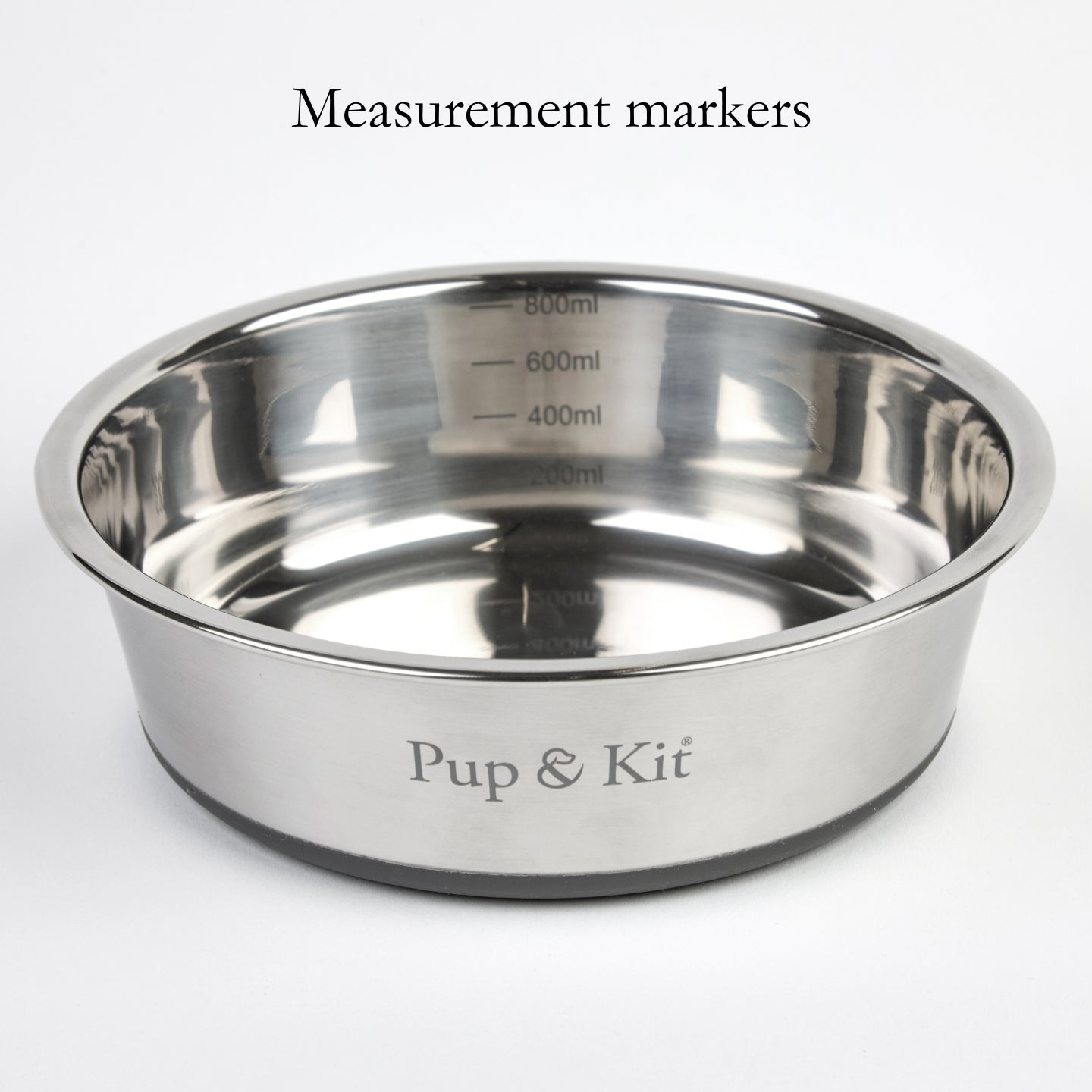 Close-up of Pup & Kit Lid-it stainless steel pet bowl showing internal measurement markers in milliliters for accurate portioning.