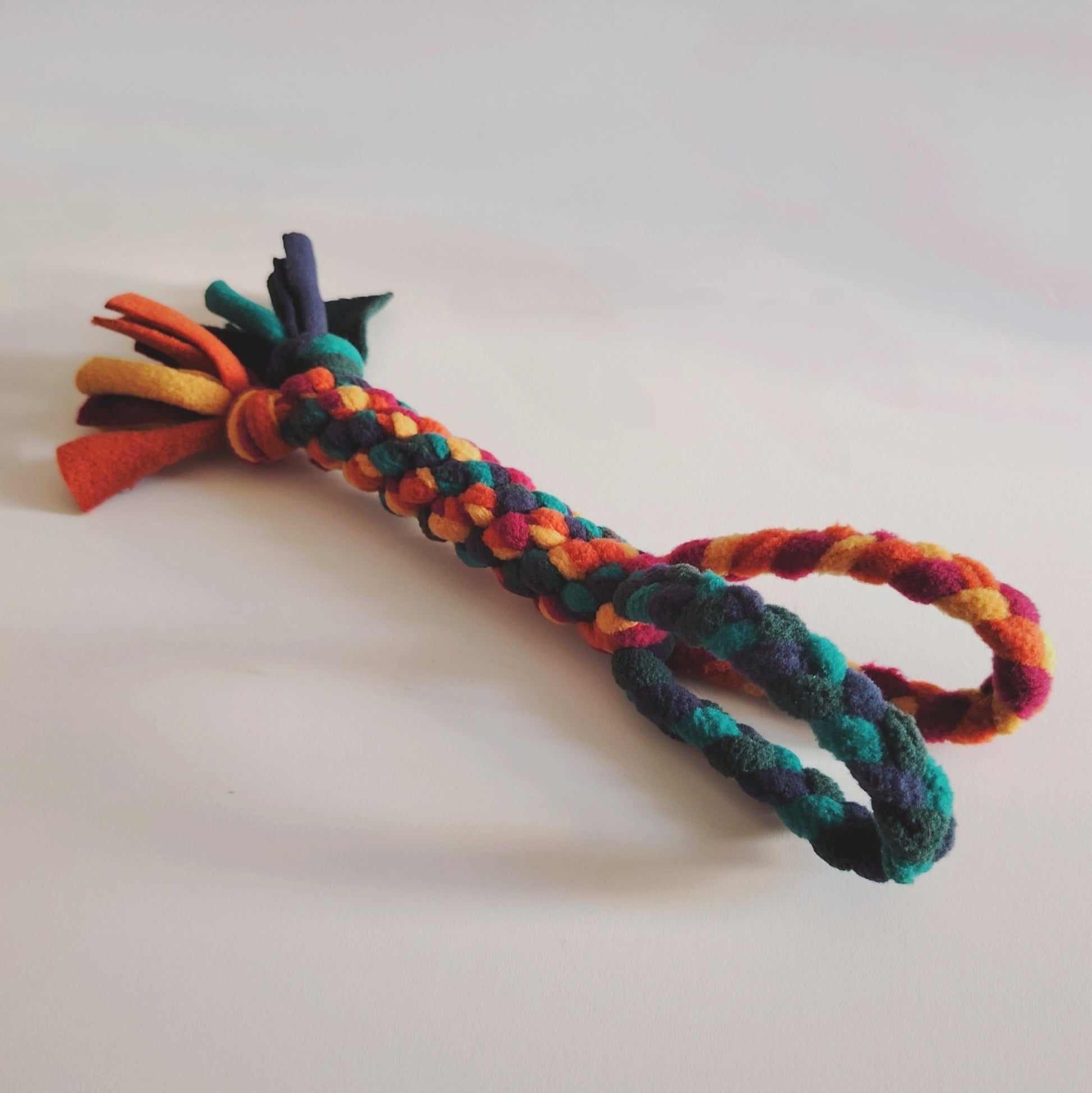 Warm colour fleece dog tug toy by Nova Zeal, handmade enrichment toy for interactive play.