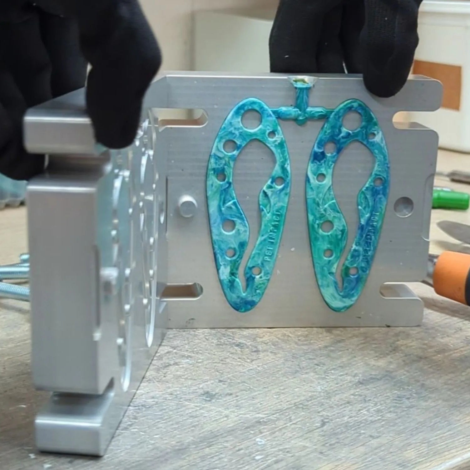Turquoise PooPal dog poo bag holders being manufactured in the UK by Brothers Make using recycled plastic