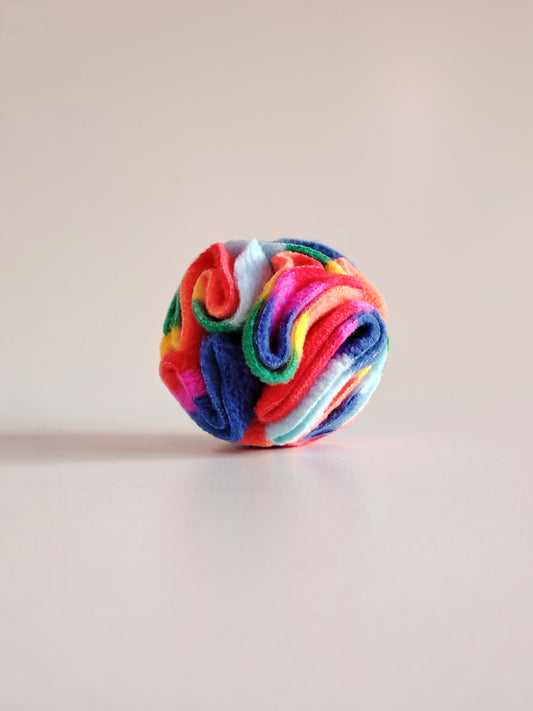 Rainbow Pocket Snuffle Ball dog enrichment toy on a light background.