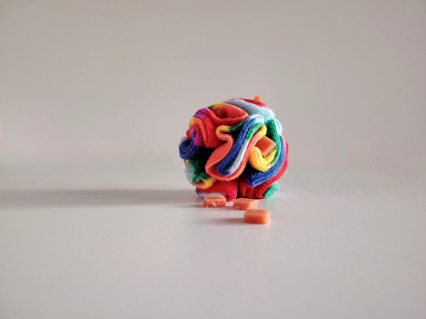 Rainbow Pocket Snuffle Ball dog enrichment toy with treats hidden in fleece folds.