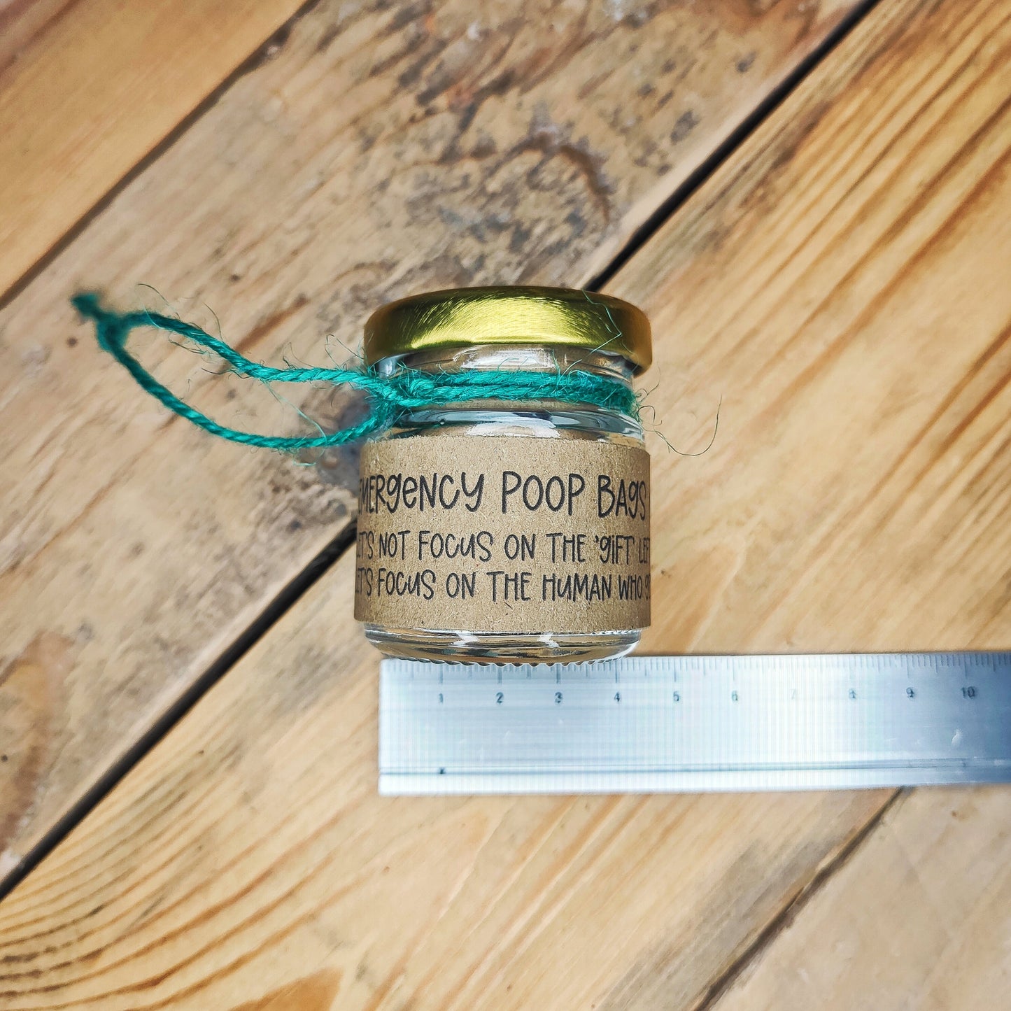 Small jar lying on its side with a metal ruler underneath, showing the width on the jar (4.5cm).