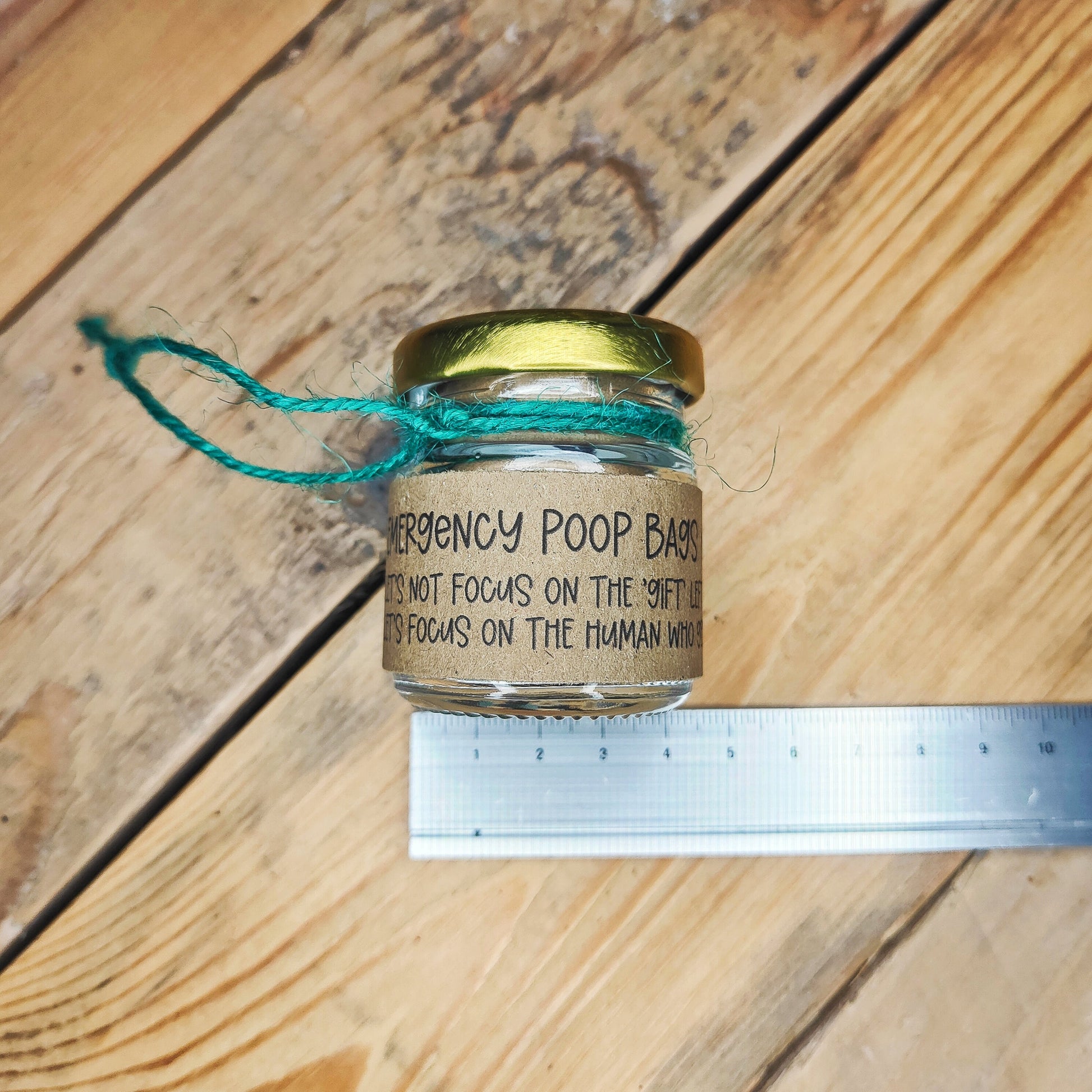 Small jar lying on its side with a metal ruler underneath, showing the width on the jar (4.5cm).