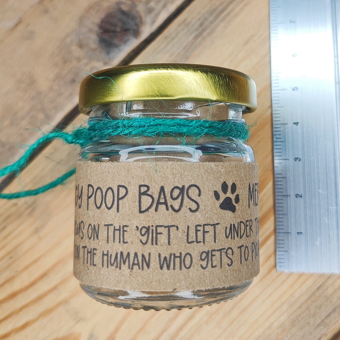 A small jar lying on its side, showing its height (5cm) 