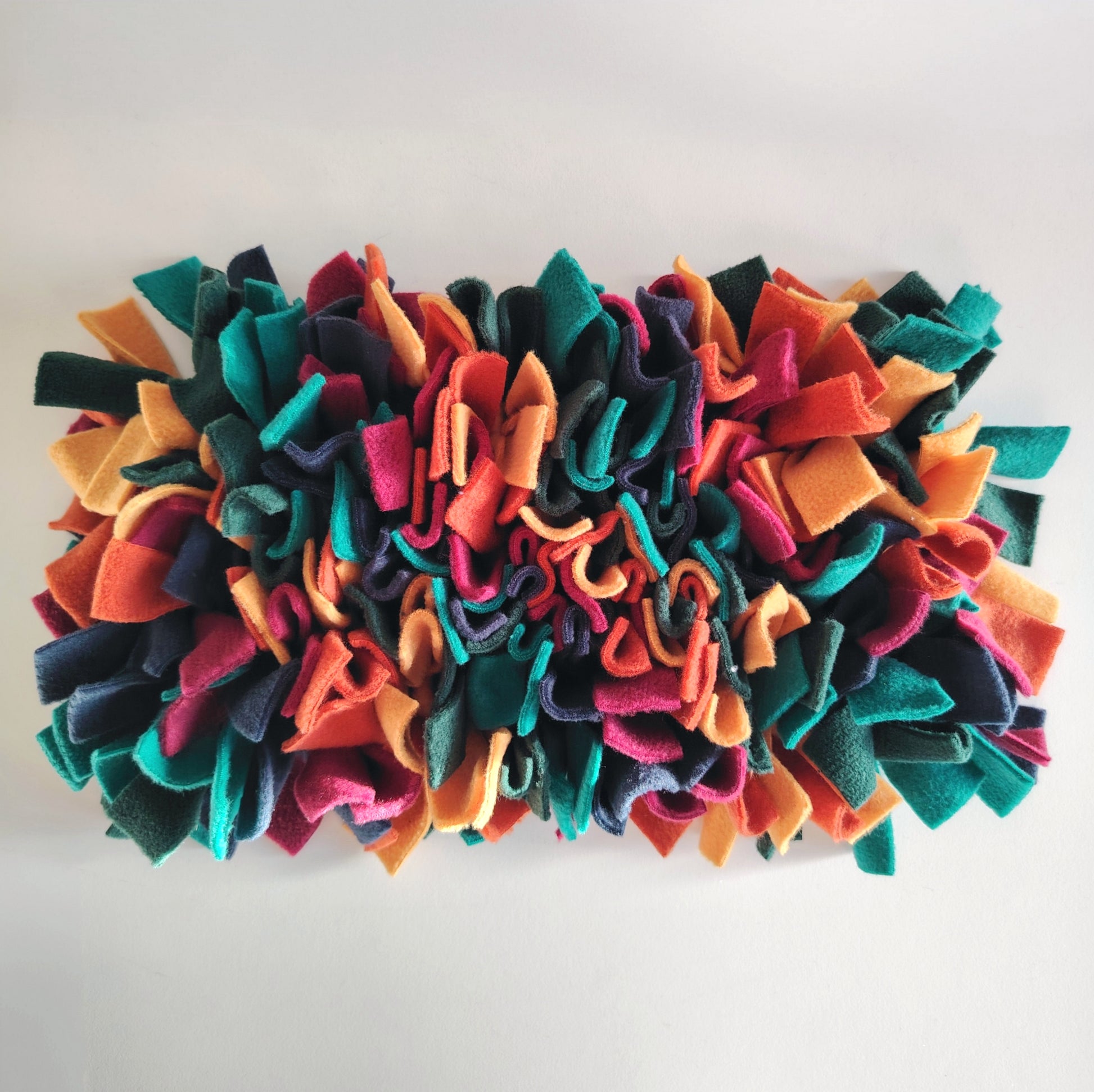 Front view of Warm-toned snuffle mat with dense fleece strips.