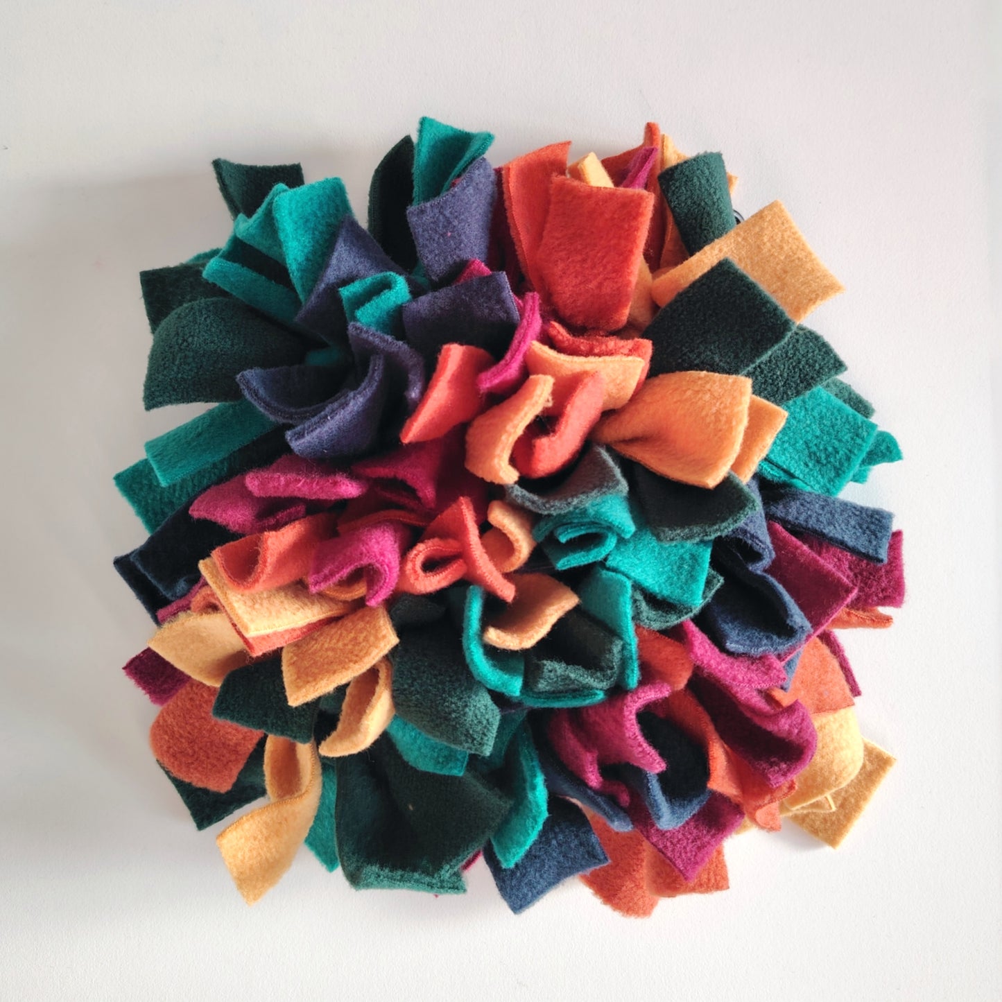 Front view of warm-toned snuffle mat with dense fleece strips.