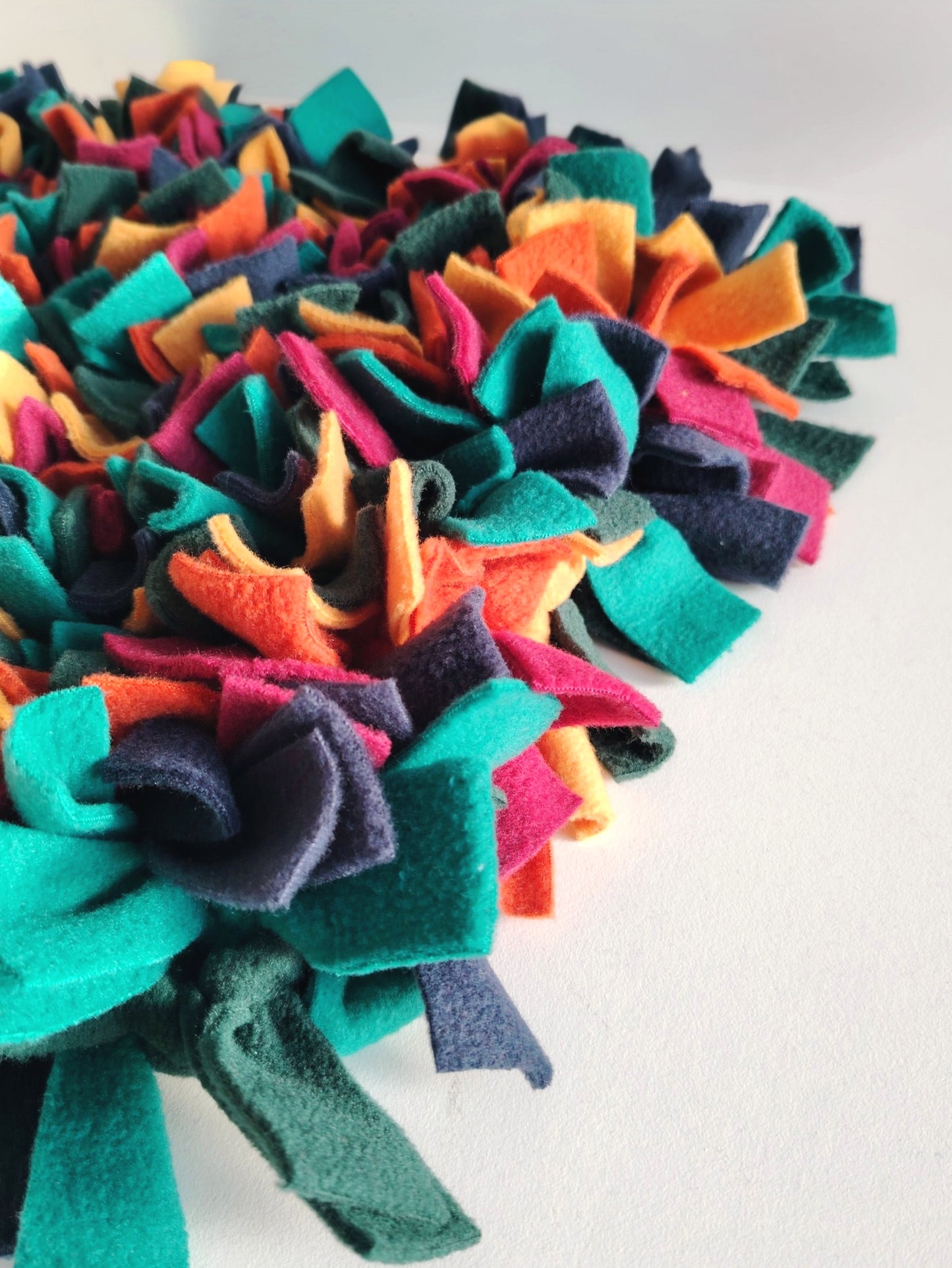 Close-up of soft fleece layers in warm-toned snuffle mat.