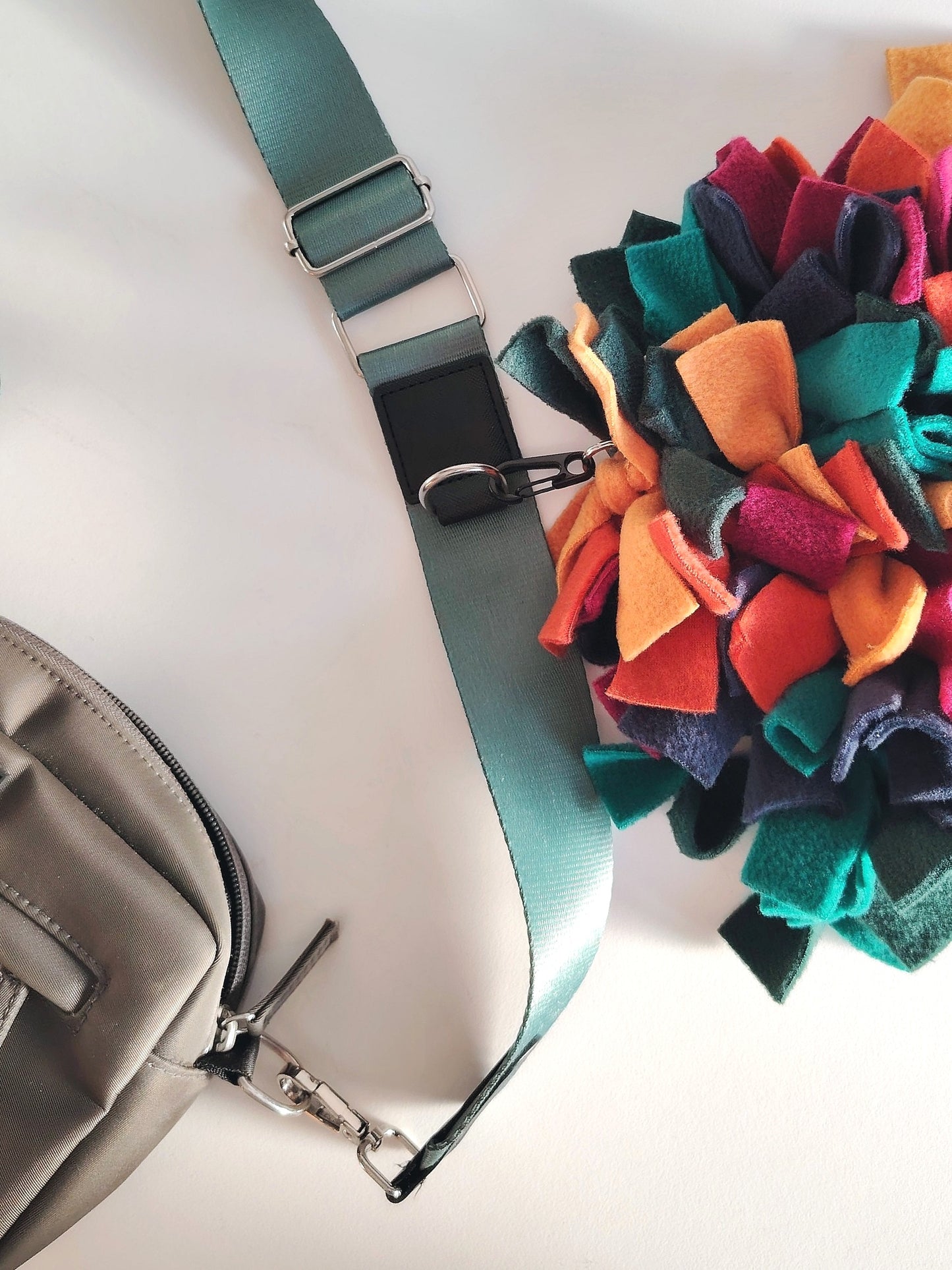 Warm-toned snuffle mat attached to a bag for enrichment while travelling.