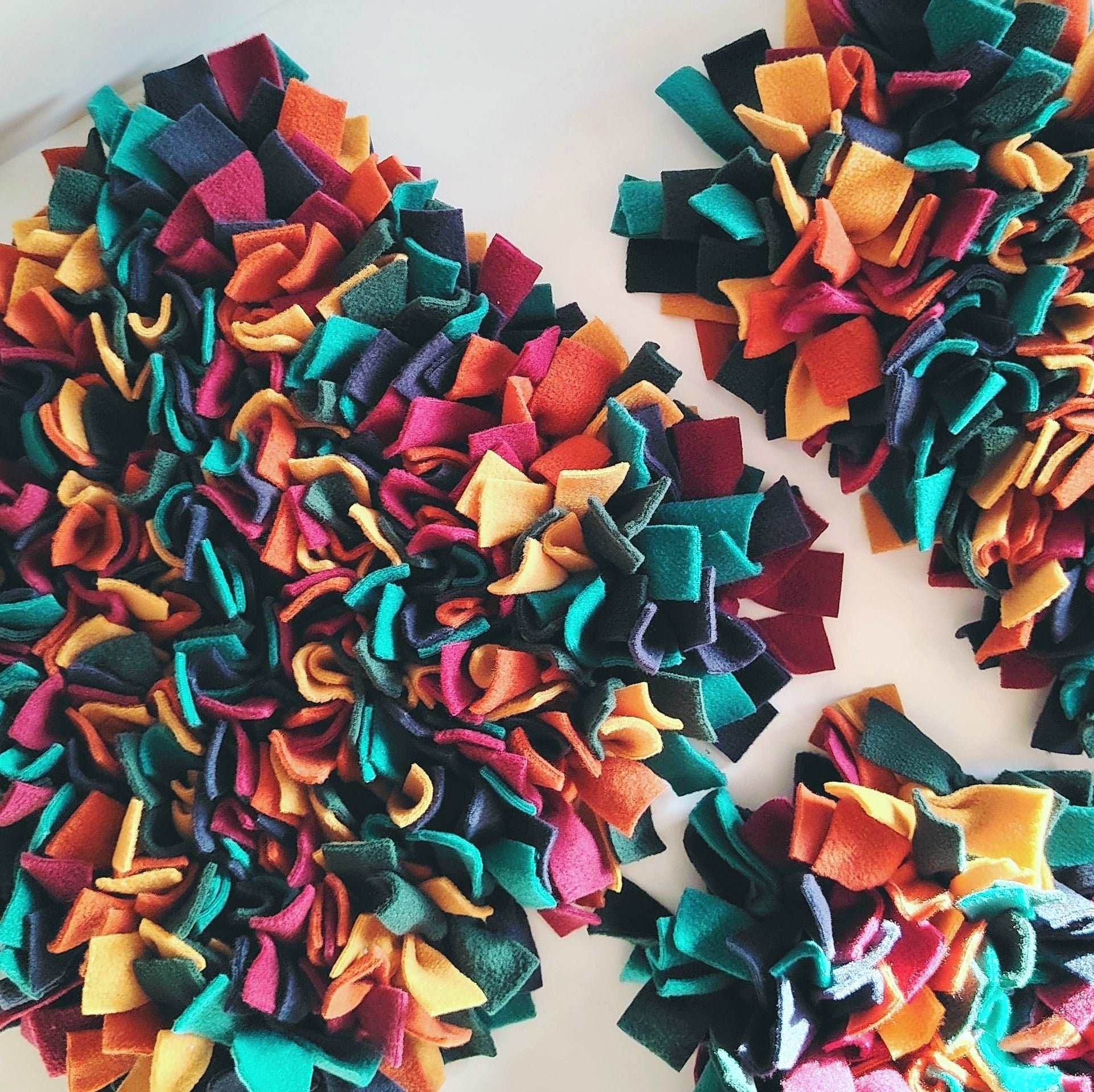 Group of warm-toned snuffle mats showing colour variation and design.