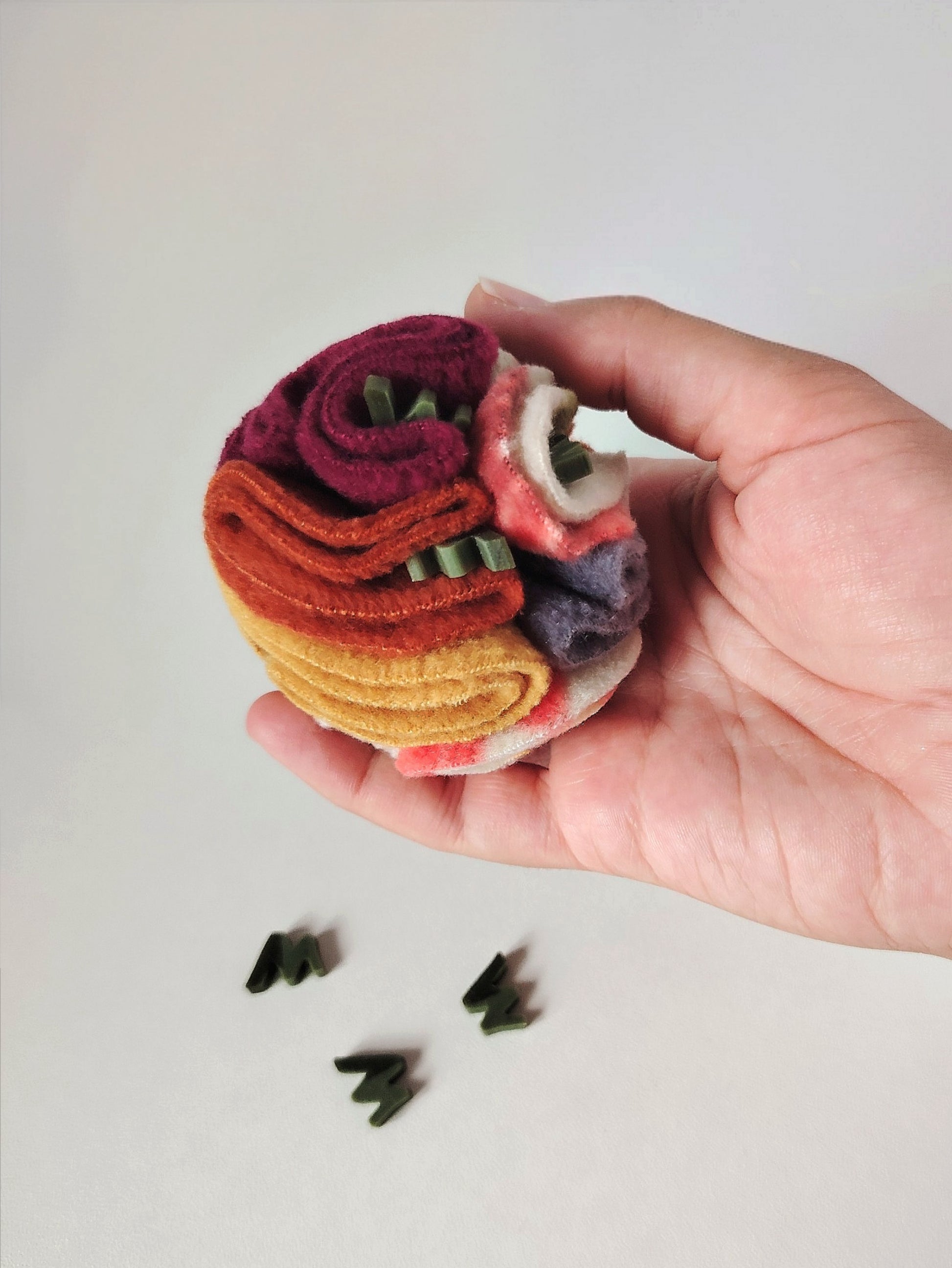 Treats being added to an Autumn Pocket Snuffle Ball ready for foraging.