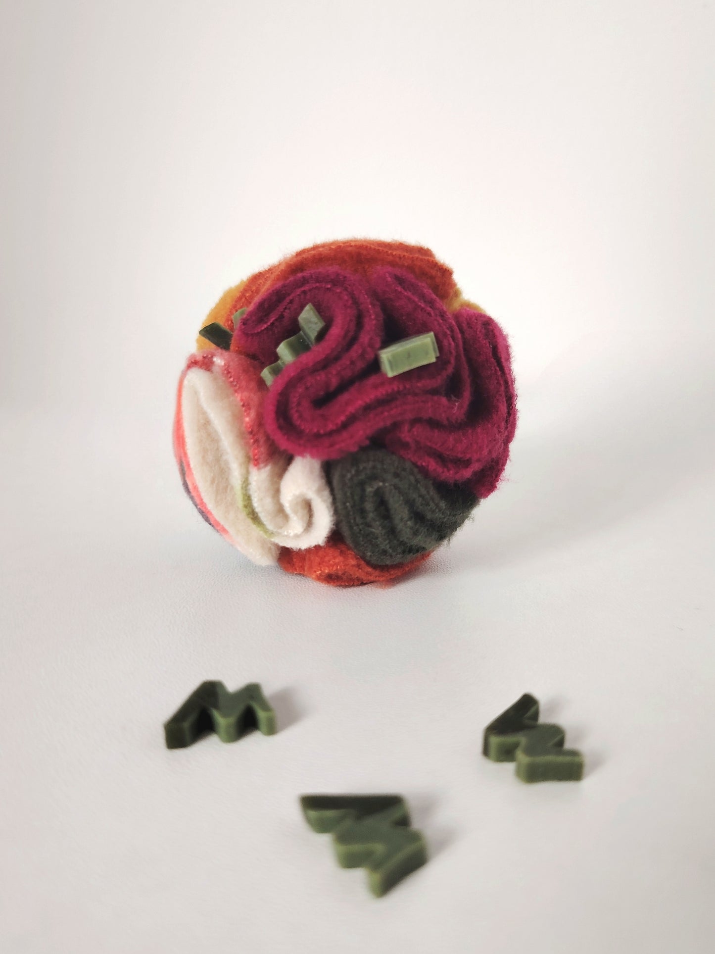 Autumn Pocket Snuffle Ball with treats hidden between the fleece folds for foraging.