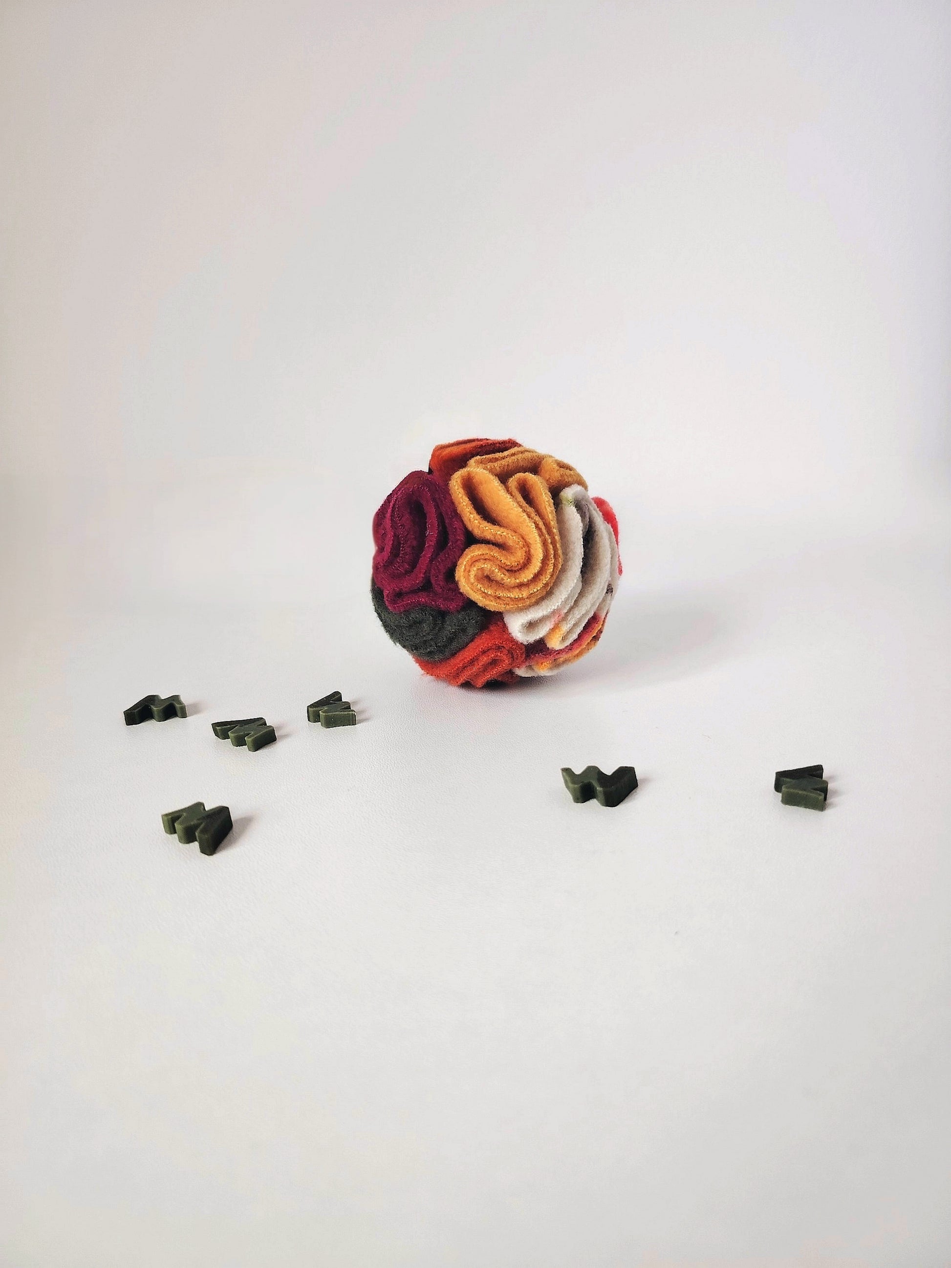 Autumn Pocket Snuffle Ball with a trail of treats ready for a foraging activity.