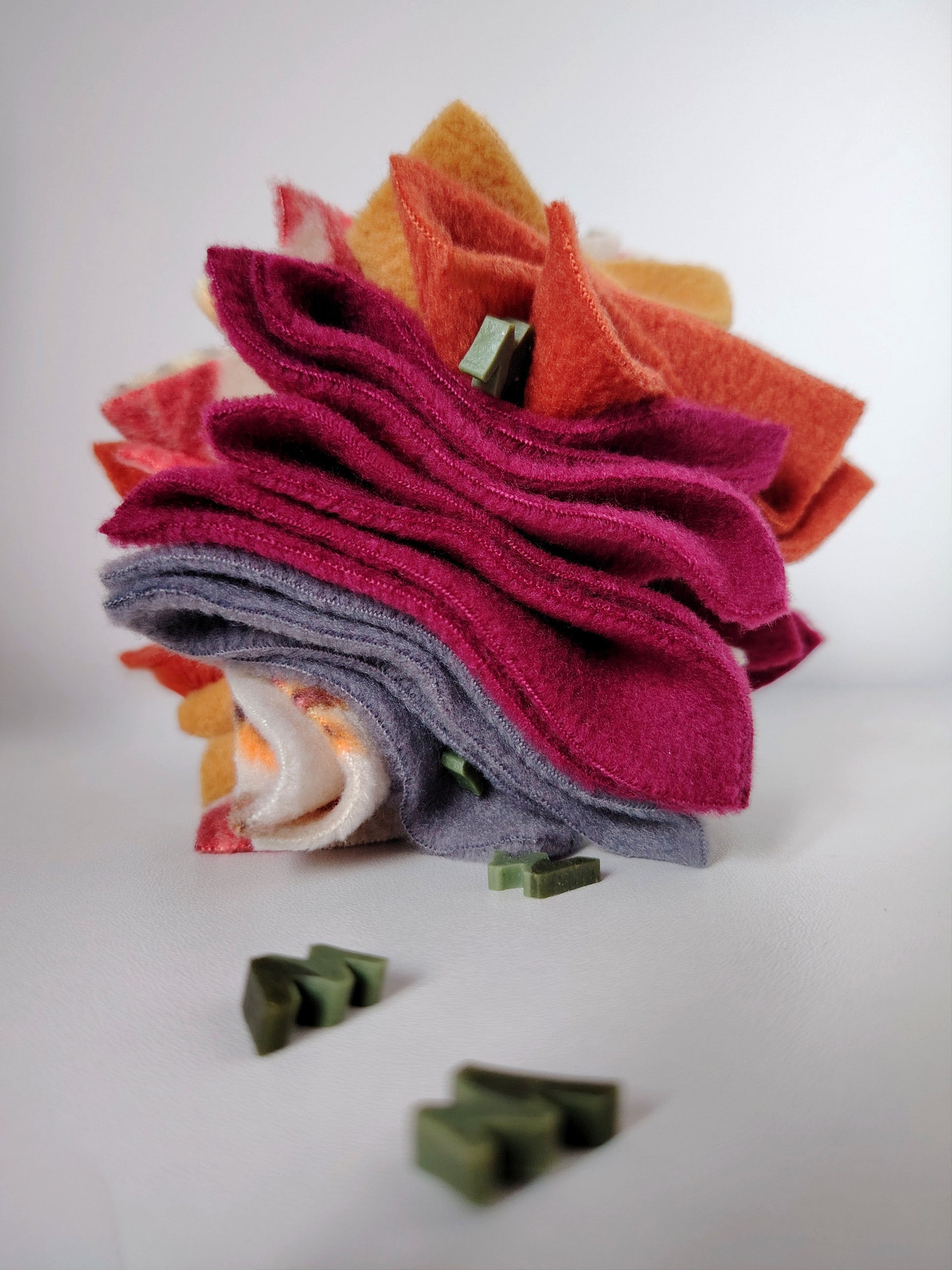 Autumn Scruffle Ball with W'ZIS dog treats hidden between layered plum, rust, mustard, green and grey fleece.