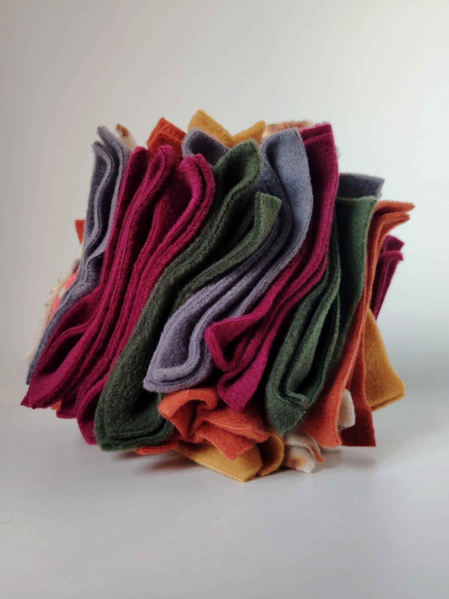 Nova Zeal Autumn Scruffle Ball handmade with layered fleece in plum, rust, mustard, green, and grey.