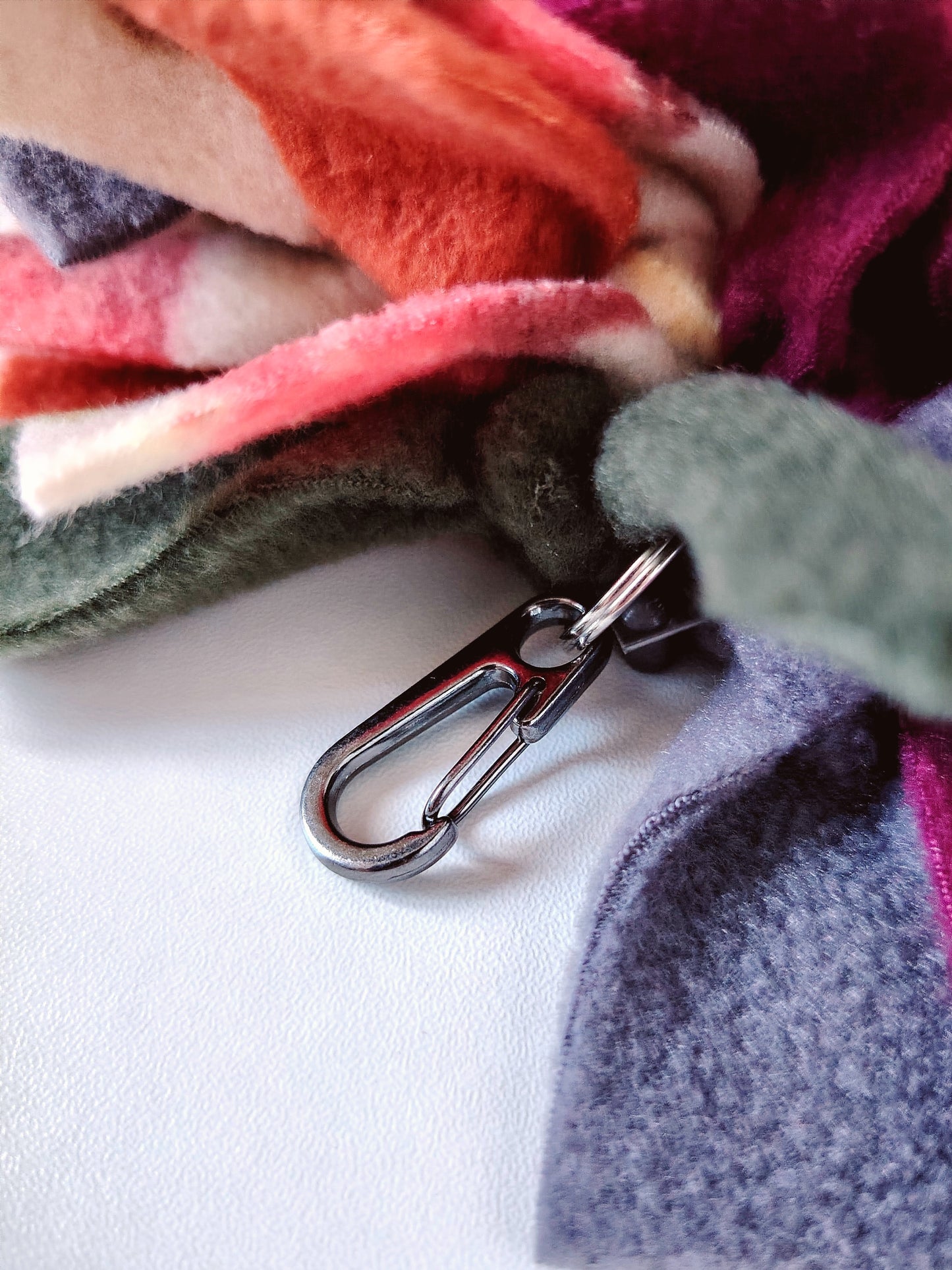 Close-up of the carabiner attachment on an Autumn Snuffle Mat for easy travel and storage.