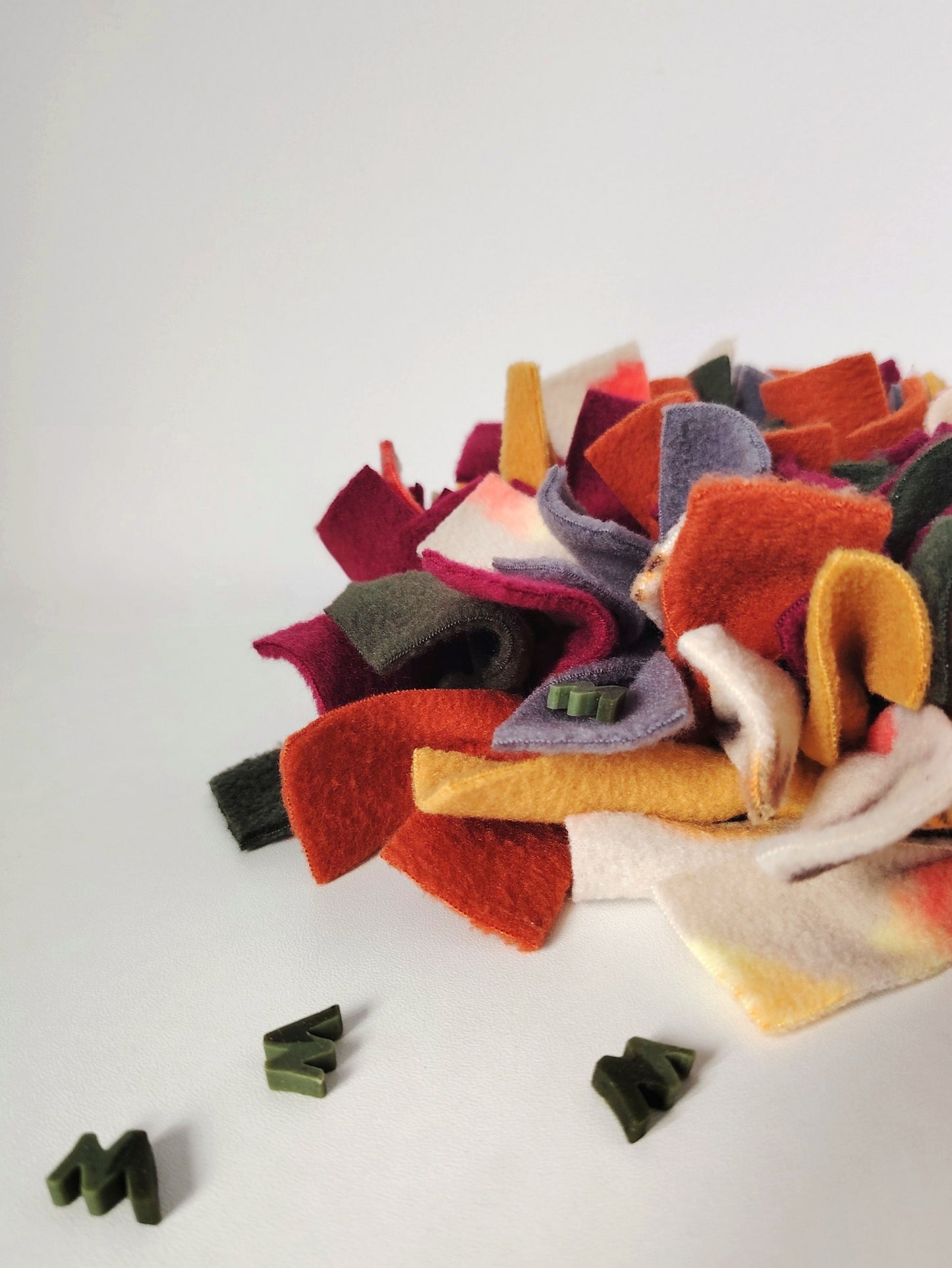 Treats hidden between the fleece strips of an Autumn Snuffle Mat.