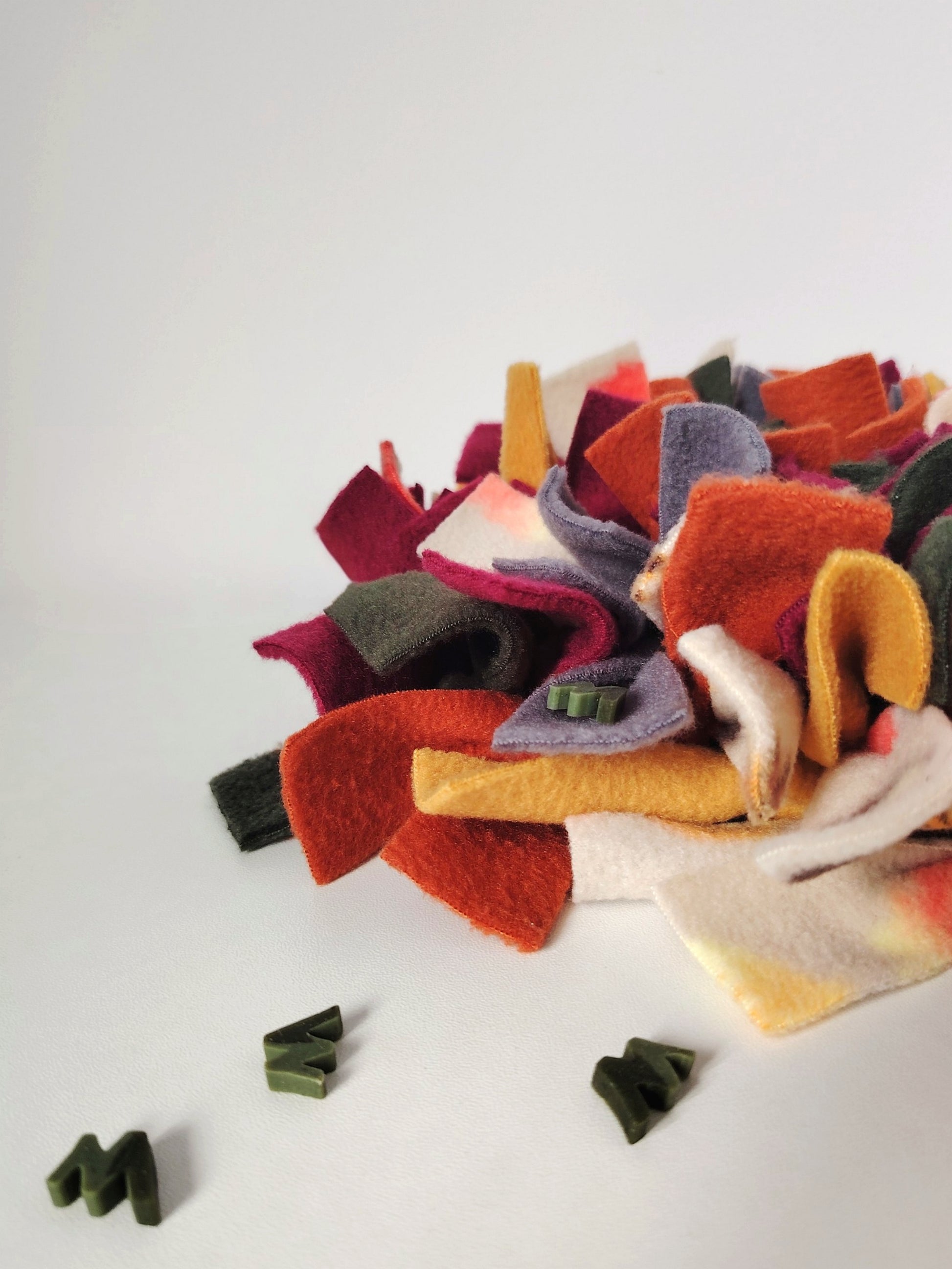 Treats hidden between the fleece strips of an Autumn Snuffle Mat.