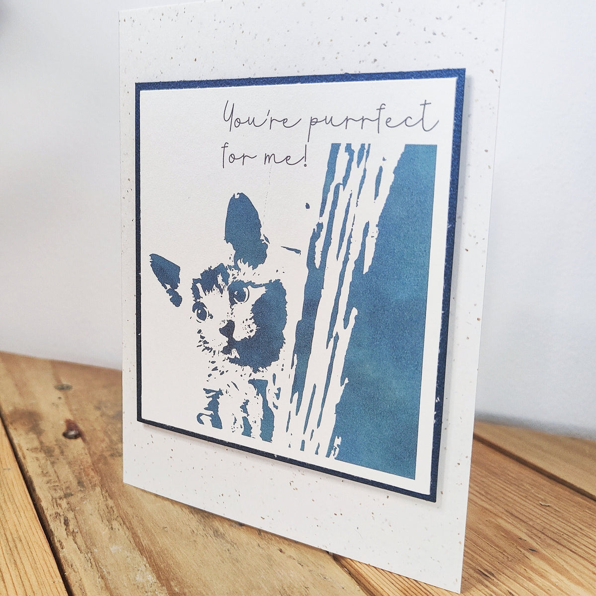 Blue "You're purrfect for me" cat card standing upright with a raised Polaroid-style kitten illustration.