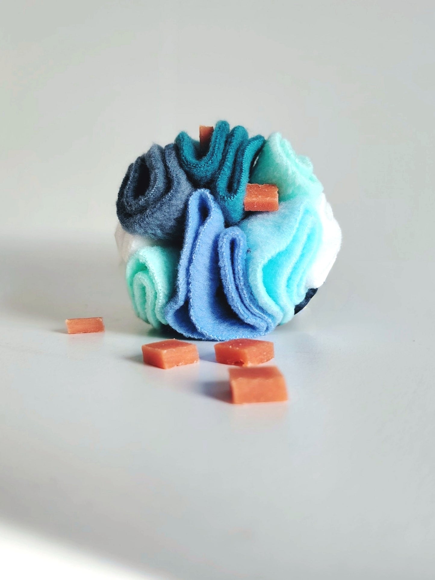 Cool colour snuffle ball with hidden treats for dog enrichment and foraging.