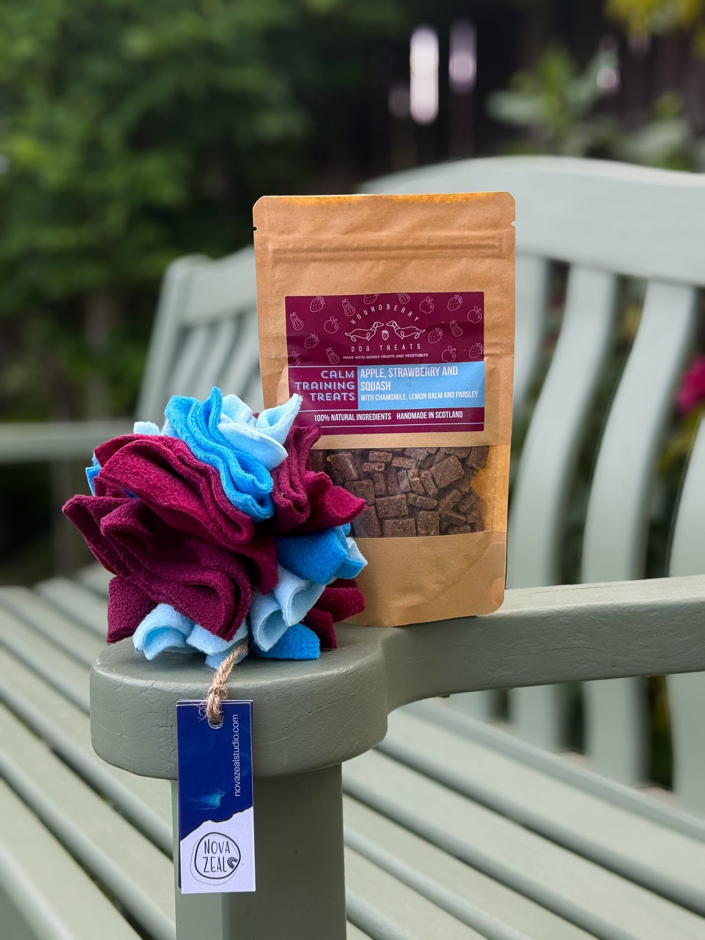 Houndberry calming treats gift set featuring a Nova Zeal small scruffle ball displayed on a garden bench.