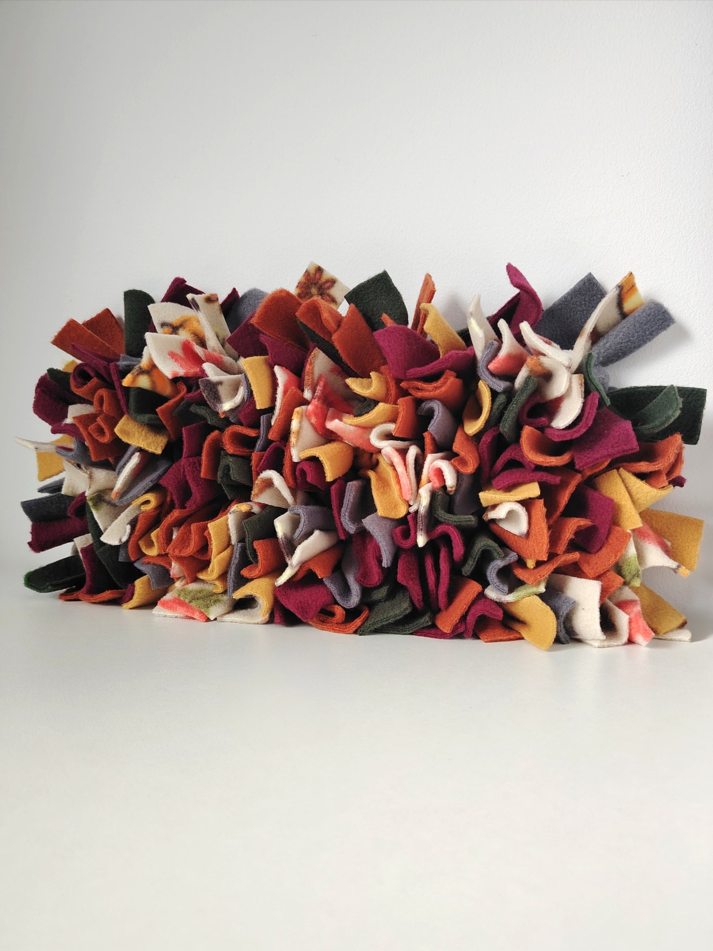 Full view of the Autumn Snuffle Mat in rust, mustard, plum, forest green, charcoal and patterned autumn fleece.