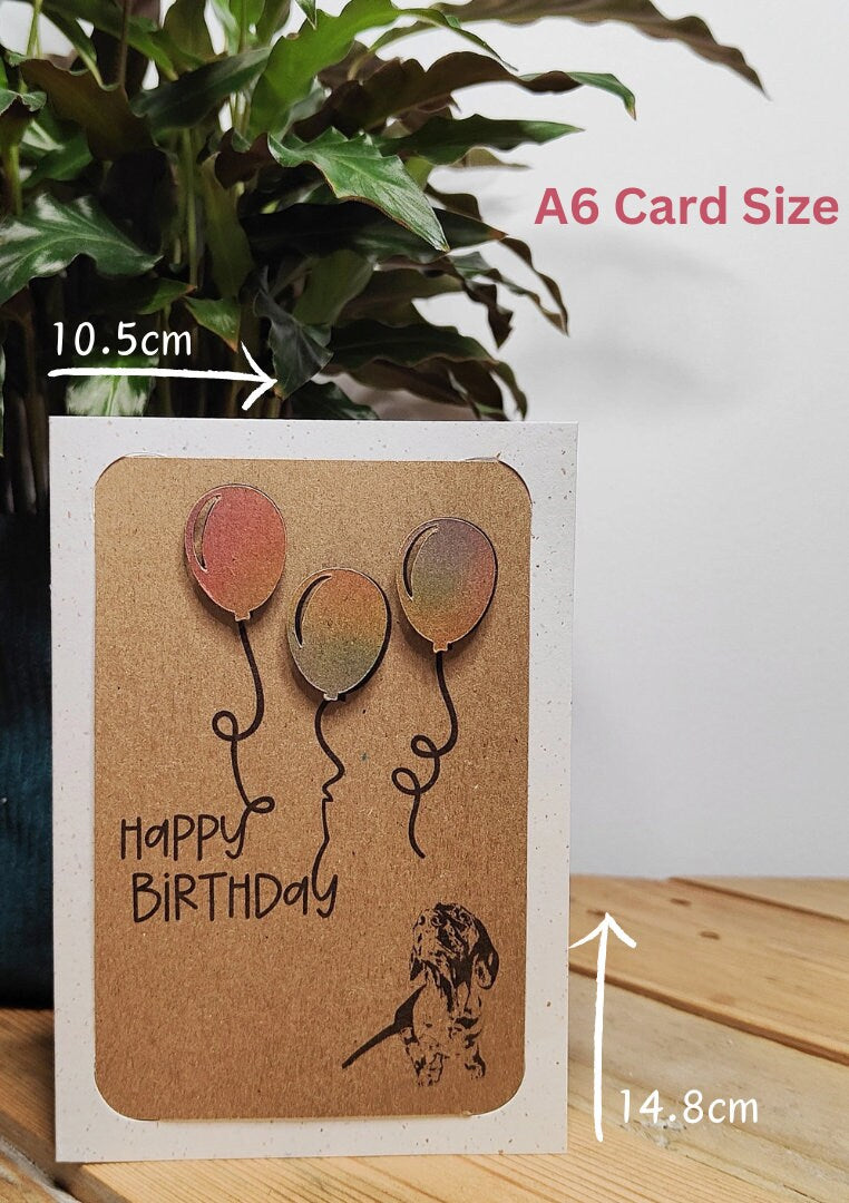 Miniature Dachshund birthday card with colourful balloons showing A6 dimensions of 14.8cm x 10.5cm