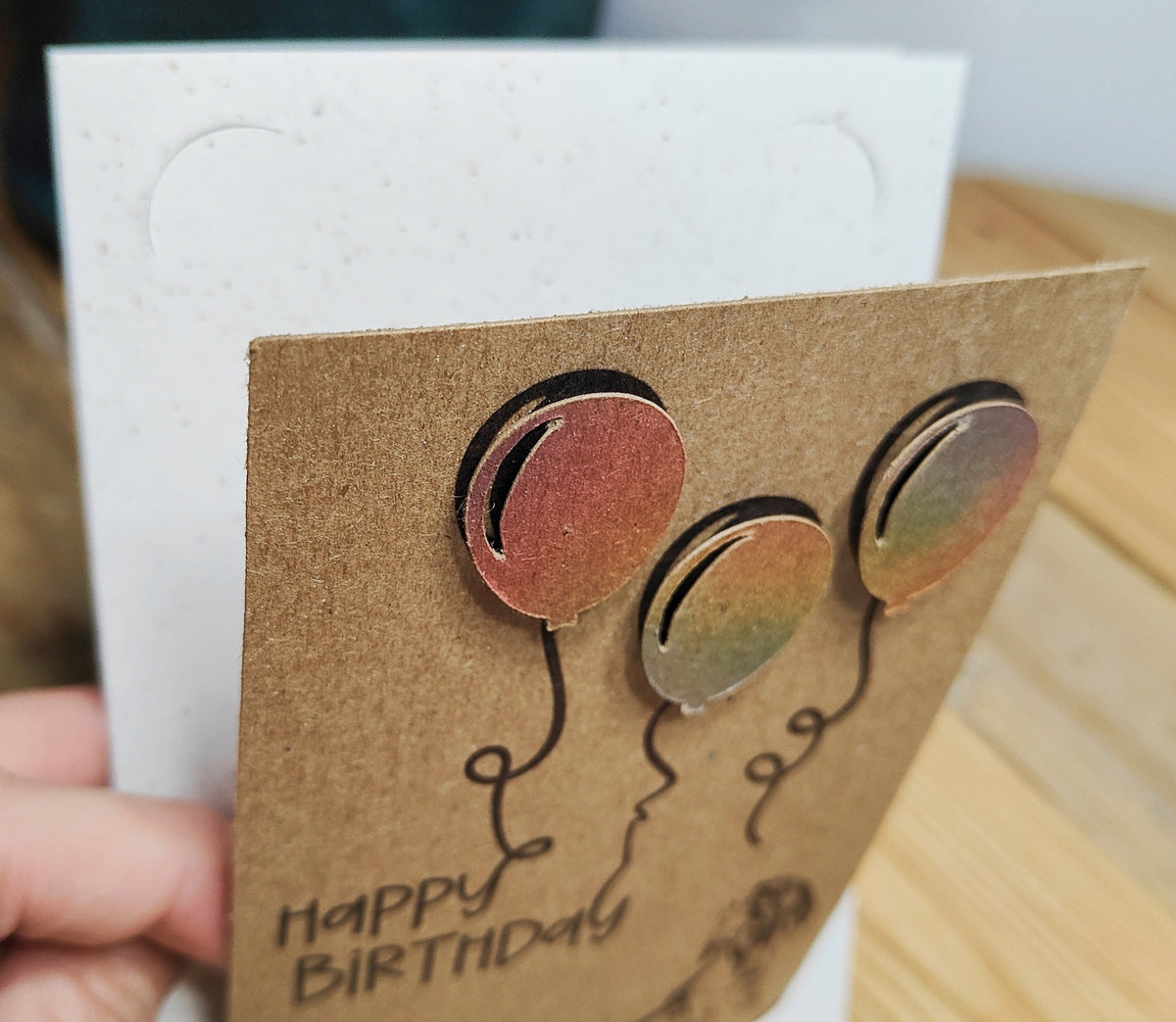 Close-up of the miniature dachshund birthday card showing the layered raised balloon detail and removable keepsake. 