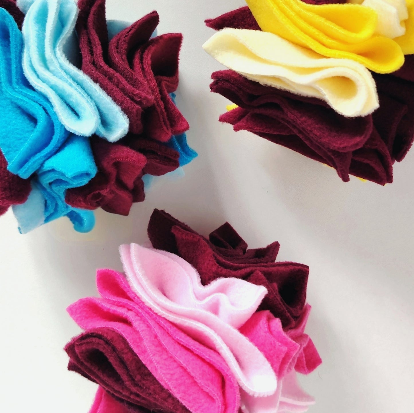 Nova Zeal Scruffle Balls in three colourful fleece designs, handmade for dog enrichment 