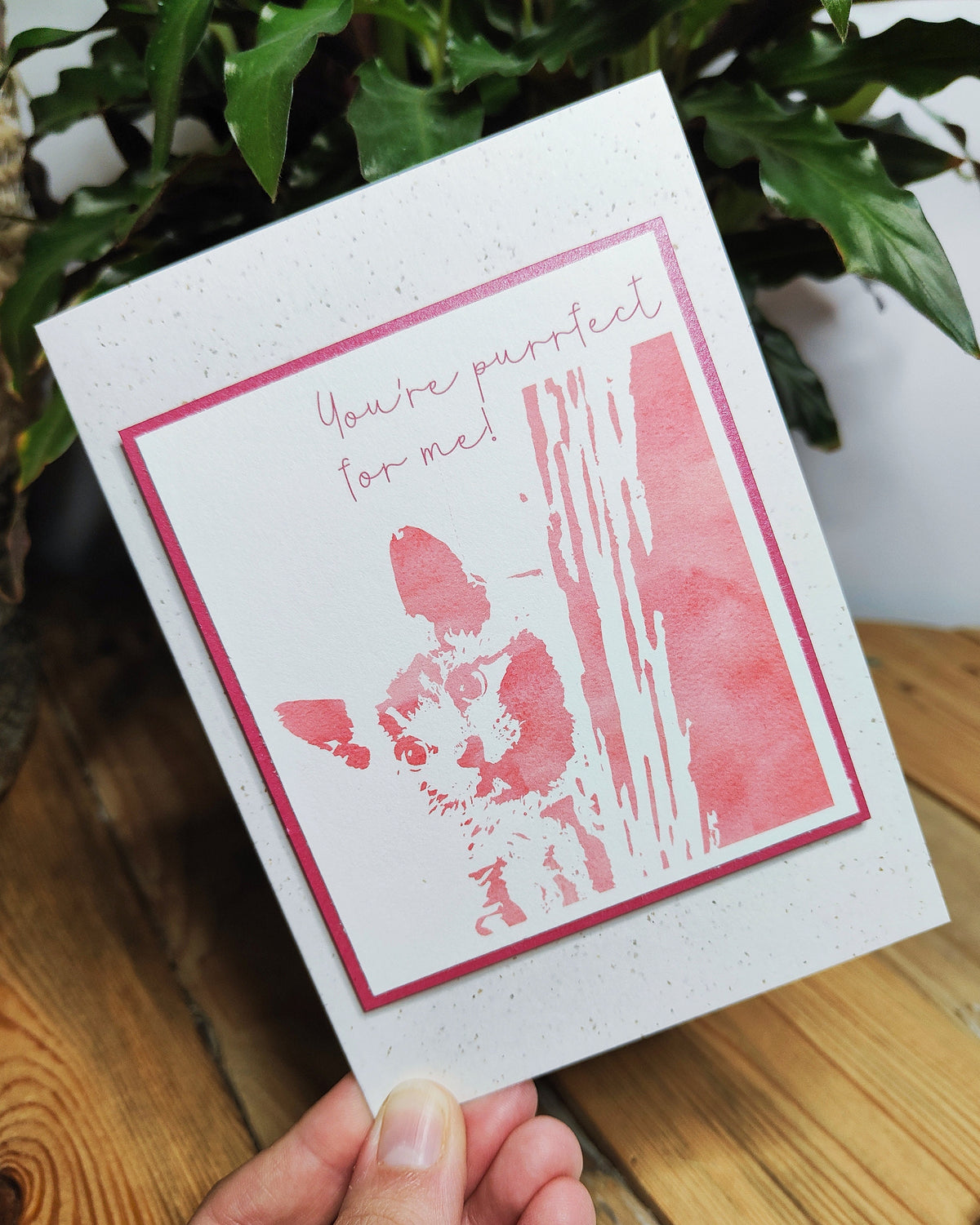 Pink cat card with a raised kitten illustration and "You're purrfect for me" message, held in hand.