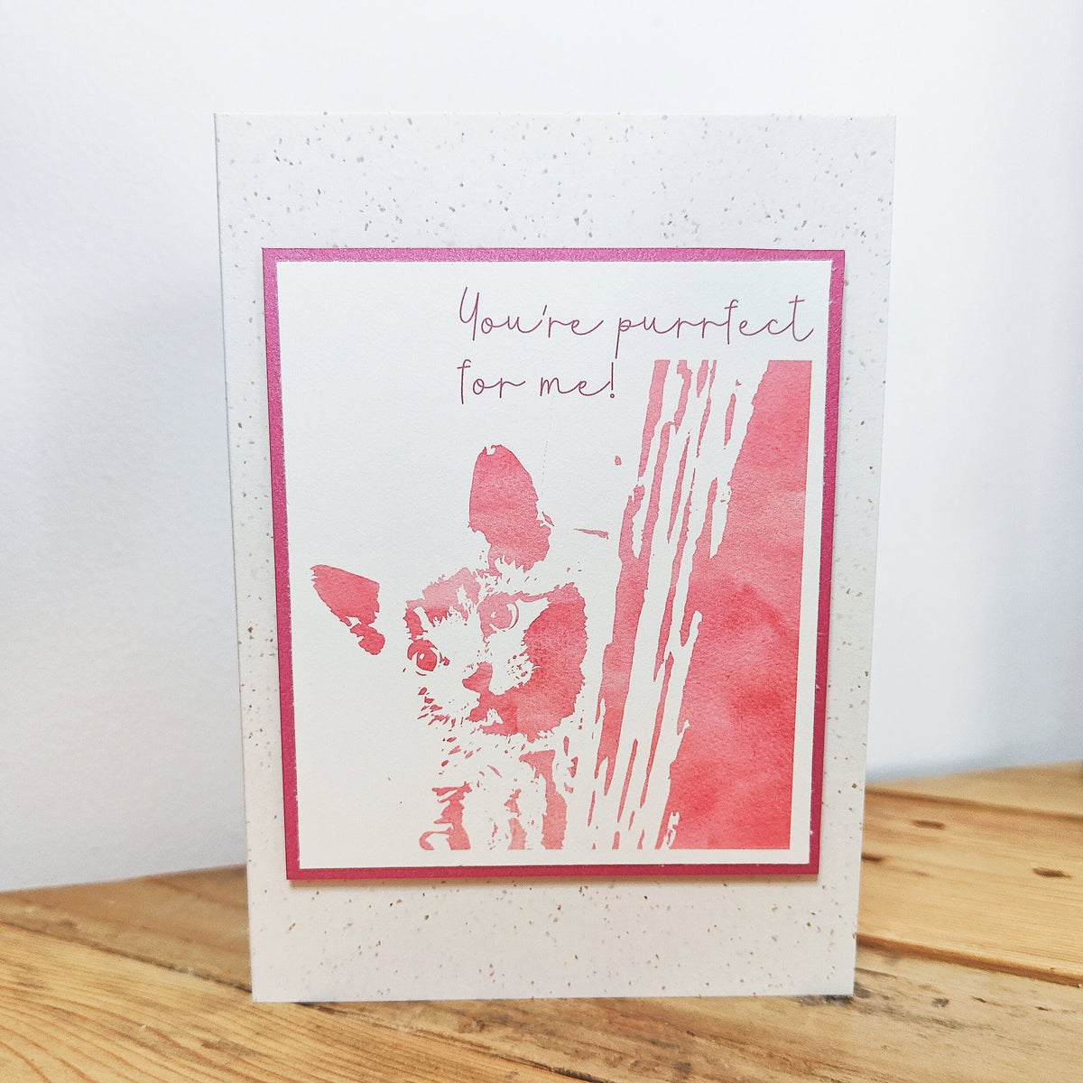 Pink "You're purrfect for me" cat card standing upright with a raised Polaroid-style kitten illustration.