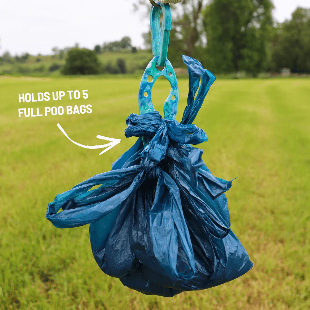 Blue PooPal holding five tied poo bags, demonstrating its maximum capacity, against a grassy outdoor background.