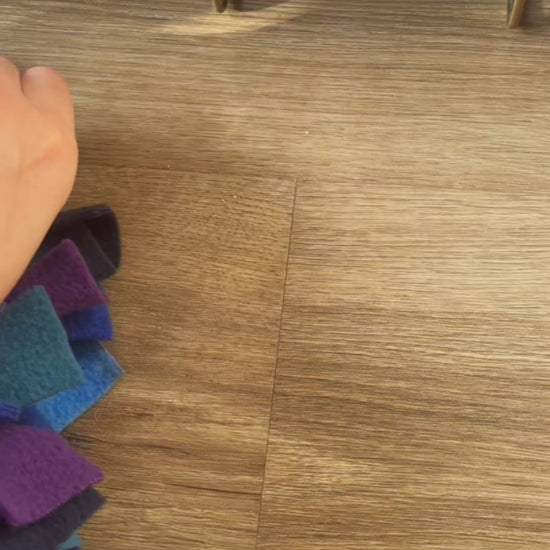 Demonstrating how the Nova Zeal Small Snuffle Mat can be attached to a dog crate, before Murphy starts sniffing and searching for hidden treats amongst the soft fleece strips.