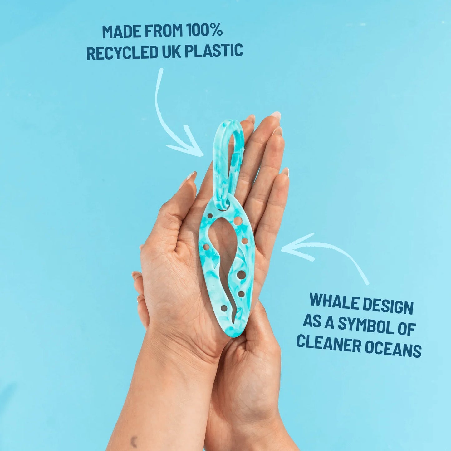 Tropical Whirlpool PooPal held in one hand, showing its whale-shaped design and turquoise marbled finish, with text explaining it is made from 100% recycled UK plastic.